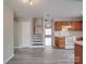 View of kitchen with hardwood style floors and an open living area with staircase at 12601 Tucker Crossing Ln, Charlotte, NC 28273