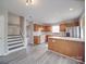 Open kitchen and eat in area with stainless steel appliances and hardwood style floors at 12601 Tucker Crossing Ln, Charlotte, NC 28273