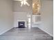 Spacious living room featuring fireplace, ceiling fan, and staircase to upper level at 12601 Tucker Crossing Ln, Charlotte, NC 28273