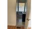 Bathroom features neutral tile flooring, a window and dark vanity at 12662 Woodside Falls Rd, Pineville, NC 28134