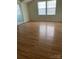 Bedroom with hardwood floors and a bright window at 12662 Woodside Falls Rd, Pineville, NC 28134