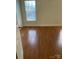 Bedroom featuring a window and wood-look laminate flooring at 12662 Woodside Falls Rd, Pineville, NC 28134