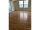 Bedroom featuring hardwood floors and windows at 12662 Woodside Falls Rd, Pineville, NC 28134