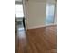 View of a bedroom with a shower, a window, and wood floors at 12662 Woodside Falls Rd, Pineville, NC 28134