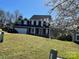 Charming two-story home featuring dark shutters and a well-maintained lawn on a sunny day at 12662 Woodside Falls Rd, Pineville, NC 28134