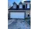 Olive green two story home featuring a spacious two car garage with a concrete driveway and front entrance at 12662 Woodside Falls Rd, Pineville, NC 28134