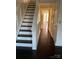 A bright foyer with hardwood floors and a classic staircase at 12662 Woodside Falls Rd, Pineville, NC 28134