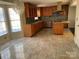 Bright kitchen features tile floors, stainless appliances, an eat-in area, and granite countertops at 12662 Woodside Falls Rd, Pineville, NC 28134