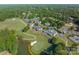 Expansive golf course community aerial view, featuring homes, trees, tennis court, and golf course at 129 Tuckernuck Dr, Mooresville, NC 28117