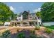Expansive backyard with patio furniture, perfect for outdoor living and entertaining surrounded by mature trees at 129 Tuckernuck Dr, Mooresville, NC 28117