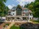 A vast backyard with beautiful landscaping, an inviting patio, and stunning architectural design ideal for relaxation at 129 Tuckernuck Dr, Mooresville, NC 28117