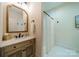 A cozy bathroom features a vanity with a mirror, a tiled shower and a toilet at 129 Tuckernuck Dr, Mooresville, NC 28117