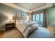 The bedroom features a king size bed, side tables with lamps and a window with curtains at 129 Tuckernuck Dr, Mooresville, NC 28117