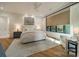 A well-lit bedroom with a large bed, neutral color scheme, and large window at 129 Tuckernuck Dr, Mooresville, NC 28117
