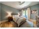 Comfortable bedroom with light blue walls, a plush rug, and modern ceiling fan at 129 Tuckernuck Dr, Mooresville, NC 28117