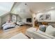 Spacious bonus room featuring beds, TV, kitchenette, and hardwood floors at 129 Tuckernuck Dr, Mooresville, NC 28117