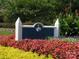 Elegant community sign surrounded by colorful flowers and manicured landscaping welcomes you to 'The Point' at 129 Tuckernuck Dr, Mooresville, NC 28117