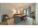 Elegant dining room with a modern chandelier, neutral tones, and a view of the backyard at 129 Tuckernuck Dr, Mooresville, NC 28117