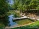 Lakeside dock providing direct access to the water, with boat lift perfect for enjoying water activities at 129 Tuckernuck Dr, Mooresville, NC 28117