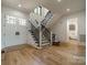 Welcoming foyer with hardwood floors, staircase with iron railing, and ample natural light at 129 Tuckernuck Dr, Mooresville, NC 28117