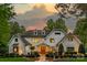 An impressive facade featuring architectural design, with a beautifully landscaped front yard that showcases curb appeal at 129 Tuckernuck Dr, Mooresville, NC 28117
