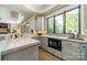 Bright kitchen features sleek countertops, modern appliances, and large windows with natural light and backyard view at 129 Tuckernuck Dr, Mooresville, NC 28117