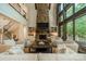 Spacious living room featuring a floor-to-ceiling stone fireplace, built-in shelves, and comfortable seating at 129 Tuckernuck Dr, Mooresville, NC 28117