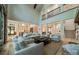 Bright and open living area featuring high ceilings, a fireplace, and seamless access to the kitchen and foyer at 129 Tuckernuck Dr, Mooresville, NC 28117