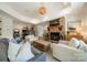 Cozy living room with stone fireplace, plush seating, and hardwood floors at 129 Tuckernuck Dr, Mooresville, NC 28117