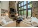 Spacious living room featuring a floor-to-ceiling stone fireplace, built-in shelves, and comfortable seating at 129 Tuckernuck Dr, Mooresville, NC 28117