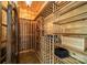 A custom-built wine cellar with wood racks, ample bottle storage, and unique iron door for elegant wine collecting at 129 Tuckernuck Dr, Mooresville, NC 28117