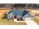 Aerial view of a well-maintained home with a landscaped yard and two-car garage at 136 Falls Leaf Dr, Troutman, NC 28166