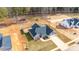 Aerial view of a private property with a large backyard and detached outbuildings at 136 Falls Leaf Dr, Troutman, NC 28166