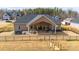 This backyard features a covered patio, hot tub, and a stylish black metal fence at 136 Falls Leaf Dr, Troutman, NC 28166