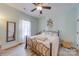 Cozy bedroom with a decorative metal bed frame, soft neutral bedding, and light hardwood floors at 136 Falls Leaf Dr, Troutman, NC 28166