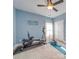 Bright bedroom featuring exercise equipment, neutral carpet, and a ceiling fan at 136 Falls Leaf Dr, Troutman, NC 28166