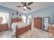 This cozy bedroom offers a wood frame bed, wood flooring and natural light at 136 Falls Leaf Dr, Troutman, NC 28166