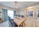 Dining room features a unique wooden table and a stylish chandelier at 136 Falls Leaf Dr, Troutman, NC 28166