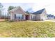 Beautiful home with manicured lawn, attractive landscaping, and a side-entry garage adding to its curb appeal at 136 Falls Leaf Dr, Troutman, NC 28166