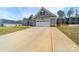 Inviting home featuring a wide driveway and attached two-car garage at 136 Falls Leaf Dr, Troutman, NC 28166