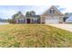 Charming single-Gathering home with a well-manicured lawn and an attached two-car garage at 136 Falls Leaf Dr, Troutman, NC 28166