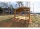 Wooden gazebo structure in backyard, sitting on a brown grass lawn at 136 Falls Leaf Dr, Troutman, NC 28166