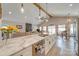 Kitchen features a marble island with a sink, and a view of the living area and dining area at 136 Falls Leaf Dr, Troutman, NC 28166