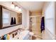 Bathroom featuring updated vanity, sink, tile shower with glass door at 1377 Buckingham Ave, Gastonia, NC 28054