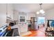 Well-lit kitchen with stainless steel appliances, white cabinets, and a modern backsplash at 1377 Buckingham Ave, Gastonia, NC 28054