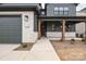 Charming front entrance with stone accents, a covered porch, and a well-lit walkway leading to the front door at 147 Windy Dell Dr, Tega Cay, SC 29708