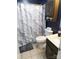 This bathroom features a white toilet, vanity with sink, and a shower with marble print curtain at 1609 Indian Springs Nw Dr # 35, Conover, NC 28613