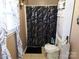 This bathroom features a shower with a decorative curtain and a white toilet with built in storage at 1609 Indian Springs Nw Dr # 35, Conover, NC 28613