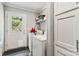 Bright laundry room features a washer, dryer, storage cabinet and an exterior door with a window for natural light at 1804 Tom Joye Rd, Clover, SC 29710