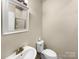 Well-lit bathroom featuring a modern sink, toilet, and shower with glass door at 1844 Burlington Dr, York, SC 29745